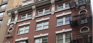 A view of the windows on the red exterior of the Esquire building