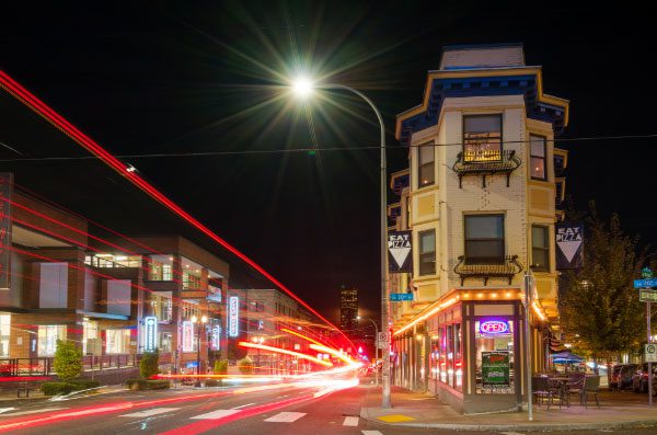 A busy street corner with streaming lights
